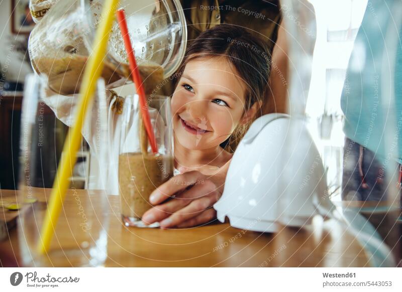 Girl pouring smoothie into glass with mother’s help kitchen daughter daughters mommy mothers ma mummy mama Smoothies child children family families people