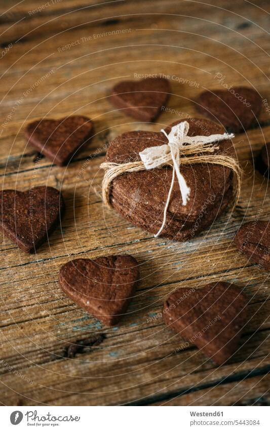 Heart-shaped chocolate shortbreads on wood food and drink Nutrition Alimentation Food and Drinks heart hearts heart shapes chocolate cookie chocolate biscuit