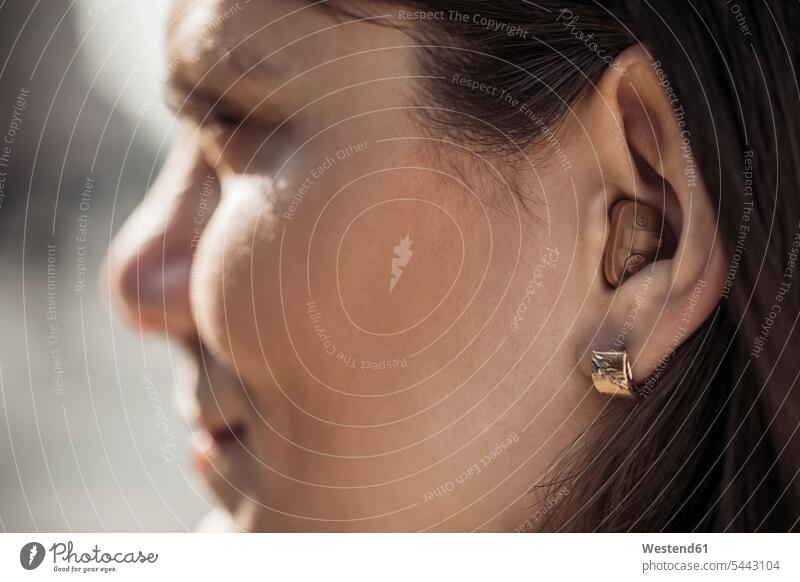 Young woman with hearing aid, close-up females women Adults grown-ups grownups adult people persons human being humans human beings healthcare and medicine