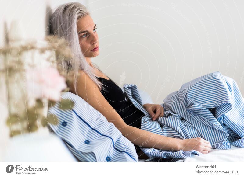 Pensive young woman in bed beds pensive thoughtful Reflective contemplative females women Adults grown-ups grownups adult people persons human being humans