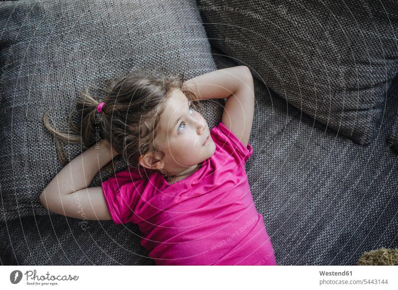 Portrait of girl lying on couch relaxed relaxation females girls settee sofa sofas couches settees laying down lie lying down relaxing child children kid kids
