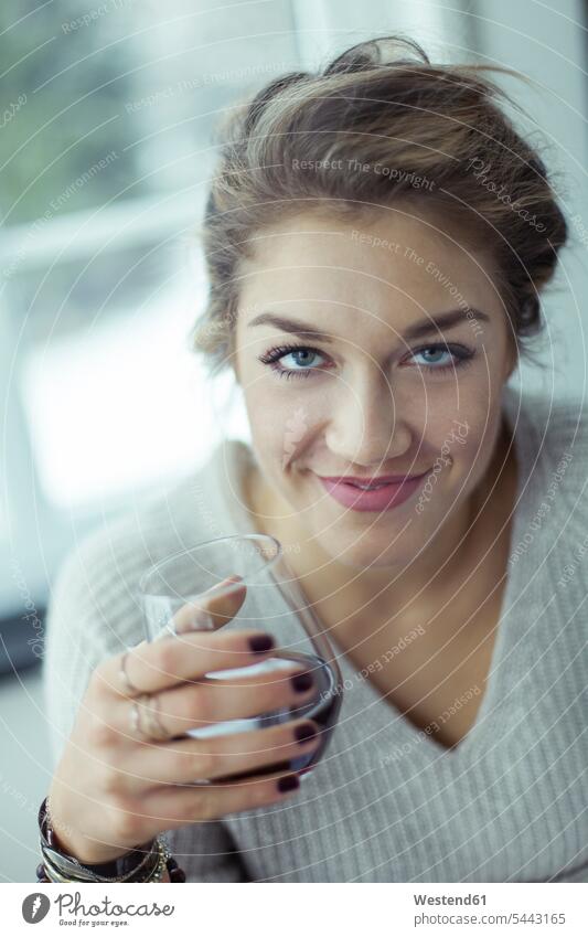 Portrait of smiling young woman with glass of coffee females women portrait portraits Adults grown-ups grownups adult people persons human being humans