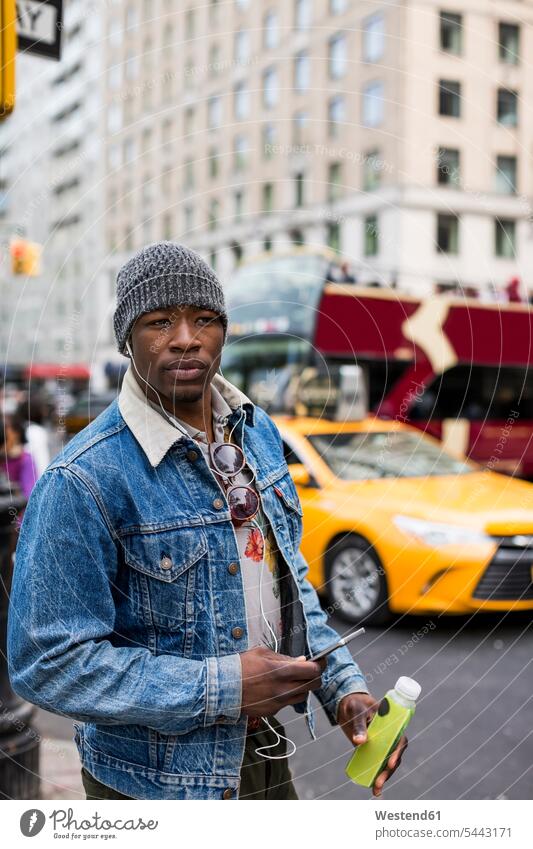 USA, New York City, Manhattan, portrait of stylish man with earphones and smartphone men males portraits Adults grown-ups grownups adult people persons