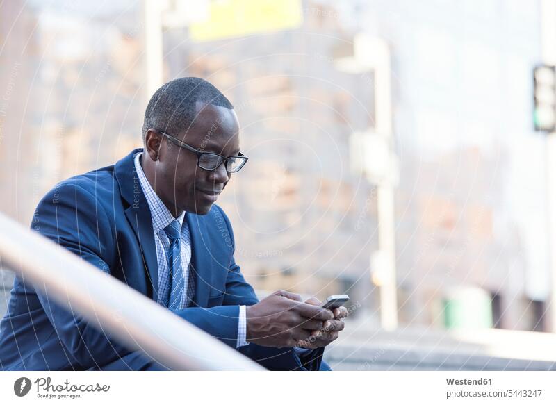 Businessman checking cell phone outdoors Business man Businessmen Business men mobile phone mobiles mobile phones Cellphone cell phones break business people