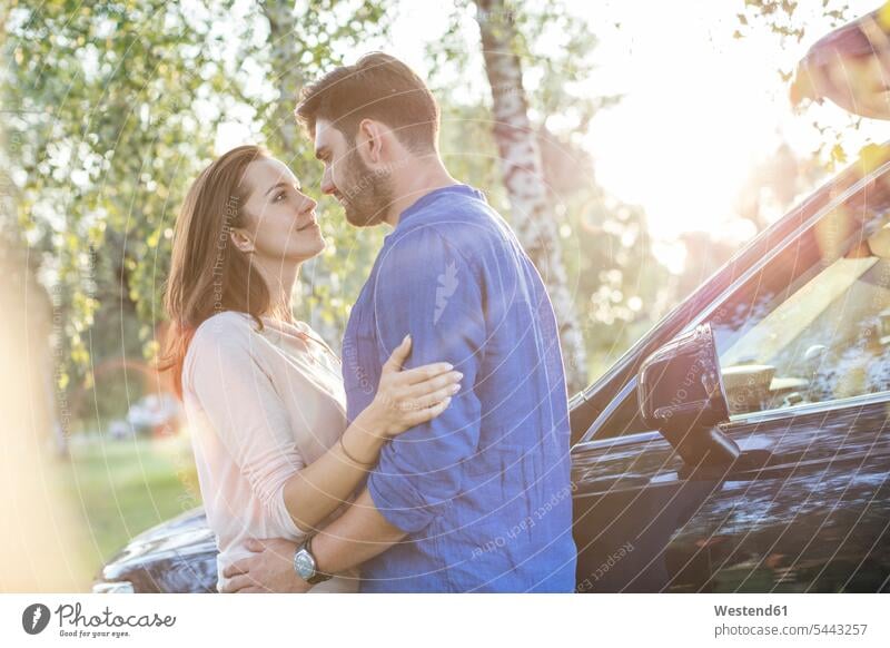 Couple embracing and kissing while on a road trip romantic lyrical Romance kisses Love loving couple twosomes partnership couples embrace Embracement hug