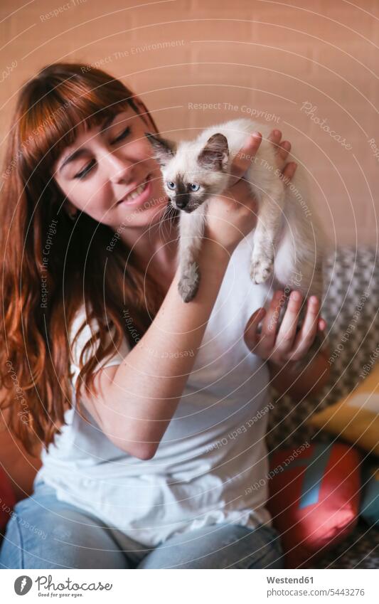 Young woman with kitten at home females women cat cats portrait portraits Adults grown-ups grownups adult people persons human being humans human beings pets
