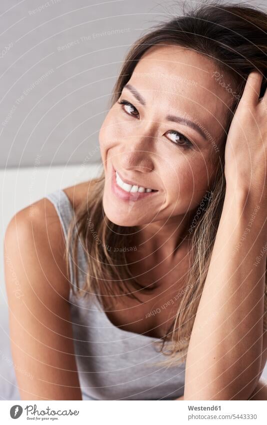 Portrait of smiling woman with head in hand smile females women portrait portraits Adults grown-ups grownups adult people persons human being humans