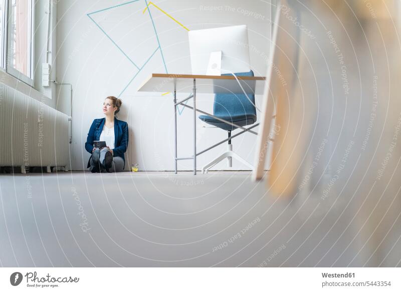 Business woman sitting on floor, looking out of window, thinking Seated ground land Internet The Internet businesswoman businesswomen business woman