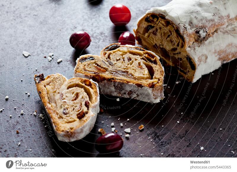 Sliced Christmas Stollen with icing sugar baking bake cut Christmas pastry Christstollen three objects 3 sliced powdered sugar Slices elevated view