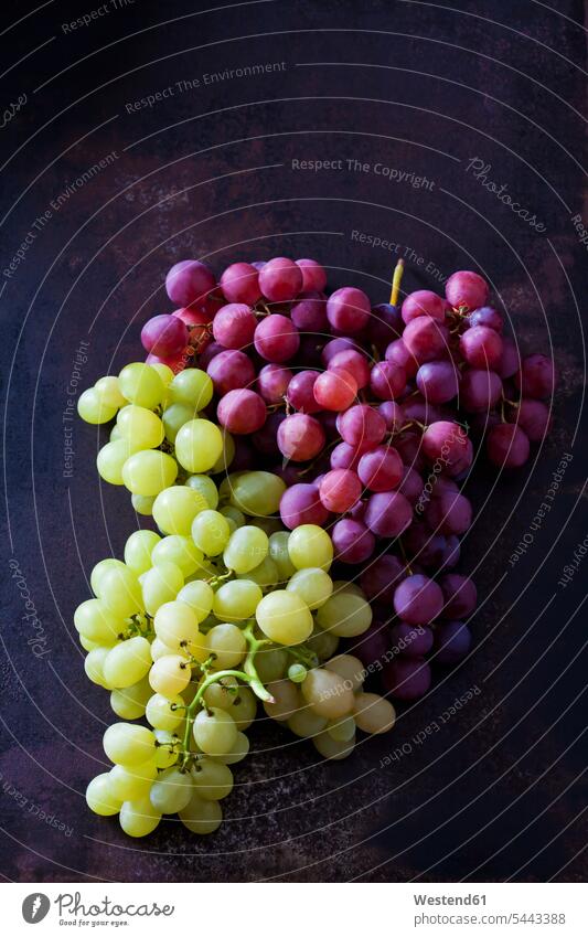 Blue and green grapes on dark metal overhead view from above top view Overhead Overhead Shot View From Above white grape white grapes blue grape red grape