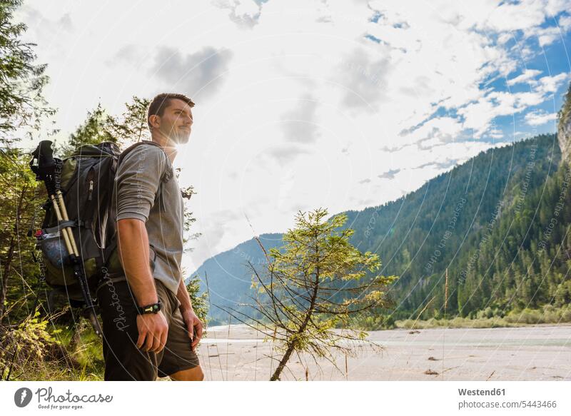 Germany, Bavaria, young hiker with backpack looking at distance men males trekking wanderers hikers Adults grown-ups grownups adult people persons human being