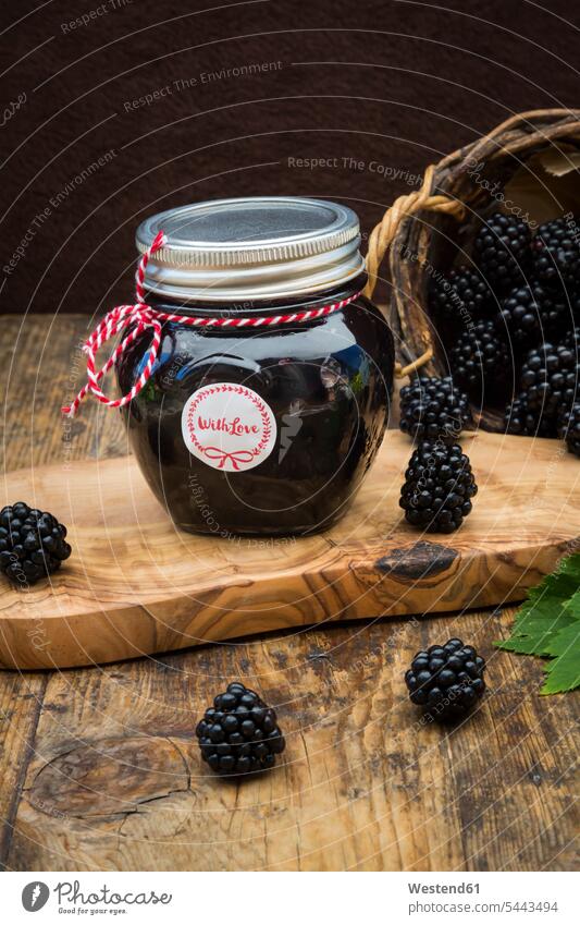 Glass of homemade blackberry jelly and blackberries on wood blackberry jam Leaf Leaves food and drink Nutrition Alimentation Food and Drinks fruity Fruit Fruits