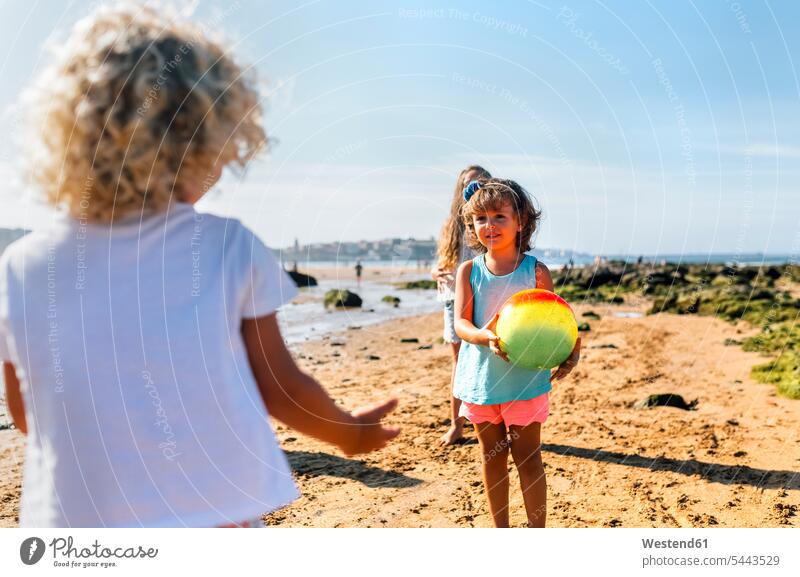 Children playing with ball on the beach girl females girls beaches child children kid kids people persons human being humans human beings friends standing