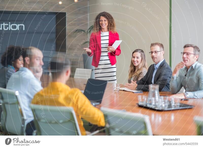 Businesswoman leading a meeting in boardroom office offices office room office rooms Business Meeting business conference conference room meeting room