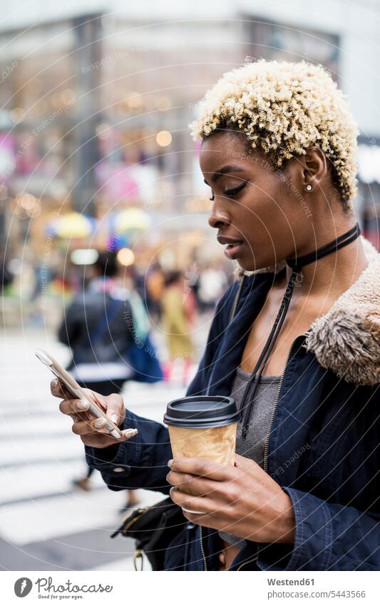 USA, New York City, portrait of young woman with coffee to go Coffee to Go takeaway coffee portraits Smartphone iPhone Smartphones looking view seeing viewing