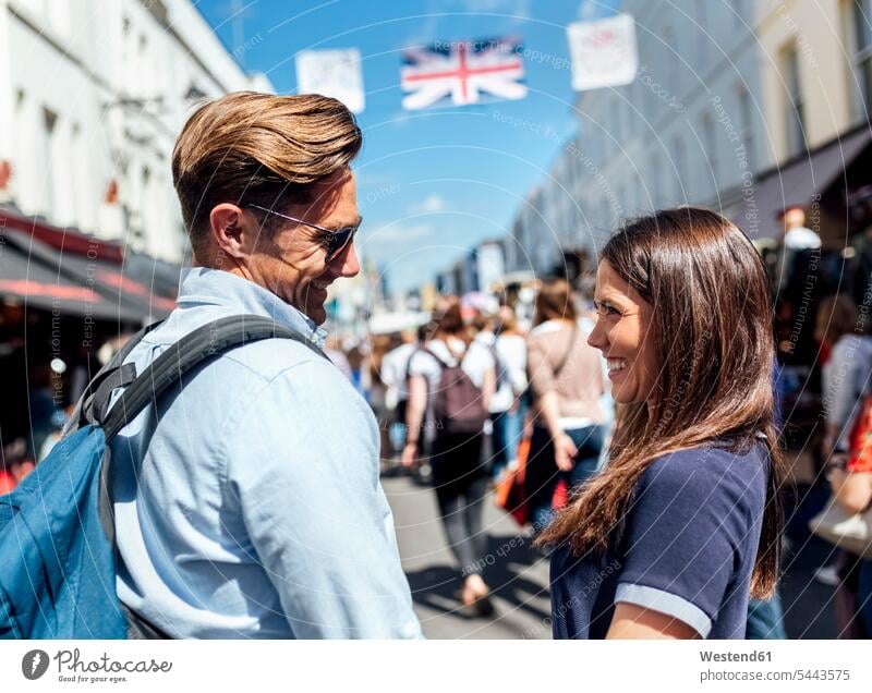 UK, London, Portobello Road, happy couple face to face twosomes partnership couples people persons human being humans human beings Market Markets Street market