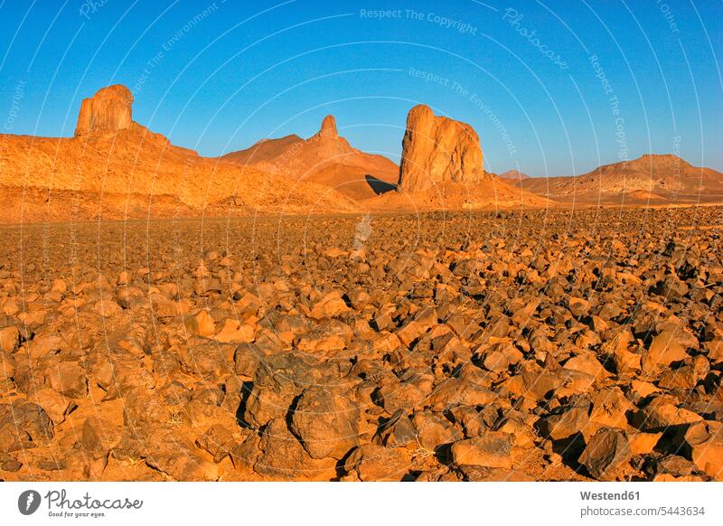 Algeria, Wilaya Tamanrasset, Hoggar Mountains, Atakor at sunlight reddish rock formation Rock Formations rural scene Non Urban Scene Highland Region Highlands