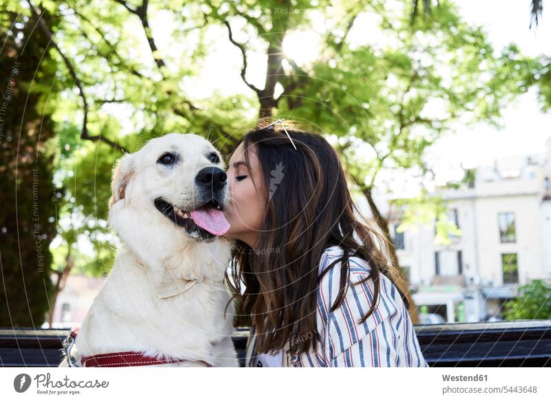 Young woman kissing her dog dogs Canine peck pecks females women pets animal creatures animals kisses Adults grown-ups grownups adult people persons human being