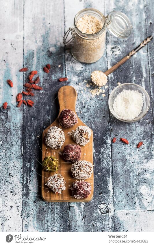 Various Bliss Balls on wooden board Energy Ball Energy Balls Glass Bowl Goji Chinese boxthorn Chinese wolfberries Lycium barbarum Chinese wolfberry Wolfberry
