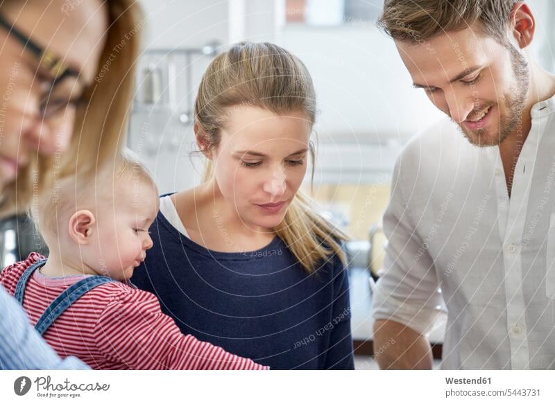 Family in kitchen looking down domestic kitchen kitchens family families people persons human being humans human beings father pa fathers daddy dads papa