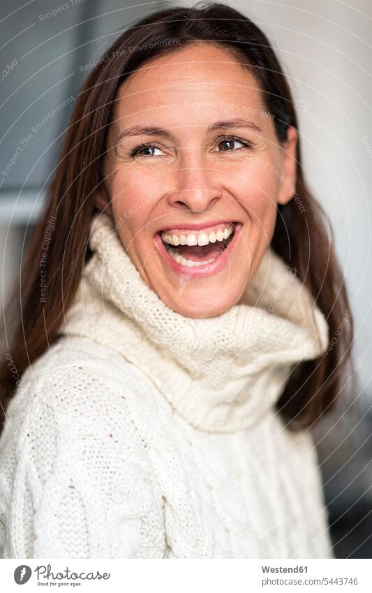 Portrait of laughing mature woman wearing white knit pullover Laughter females women portrait portraits positive Emotion Feeling Feelings Sentiments Emotions