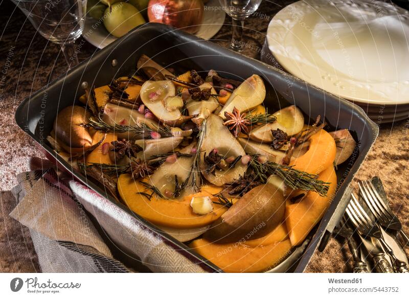 Vegan oven vegetables with pumpkin, pears and spices in roasting tray Plate dish dishes Plates ingredient ingredients laurel Laurus nobilis bay ginger root