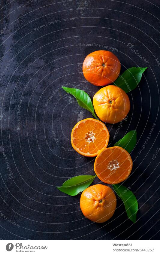 Sliced tangerines on dark backround orange copy space elevated view High Angle View High Angle Shot healthy eating nutrition half halves halved sliced juicy