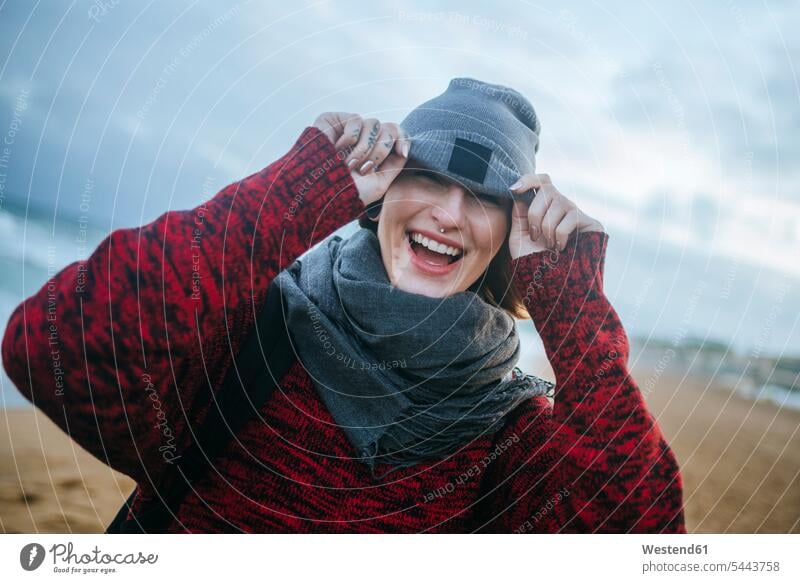 Happy young woman on the beach in winter happiness happy females women laughing Laughter beaches Adults grown-ups grownups adult people persons human being