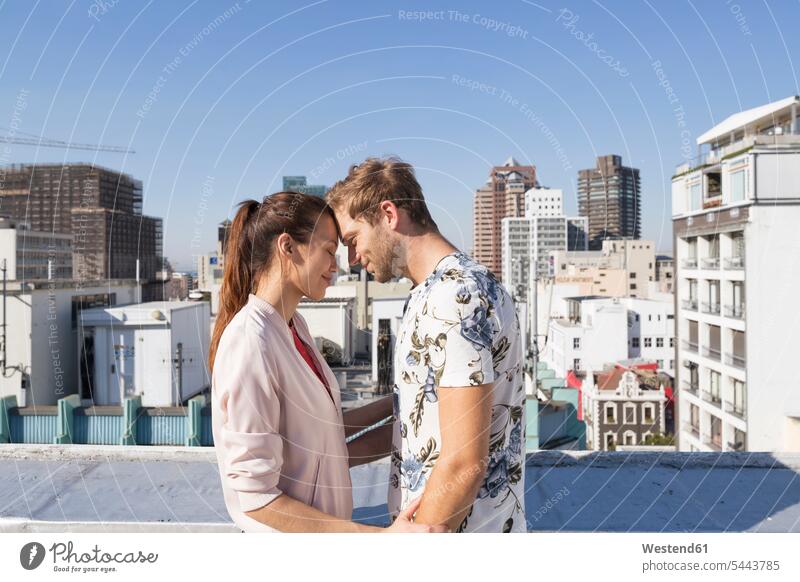 Young couple flirting on a rooftop terrace Flirtation together meeting encounter gathering friends carefree twosomes partnership couples Falling In Love