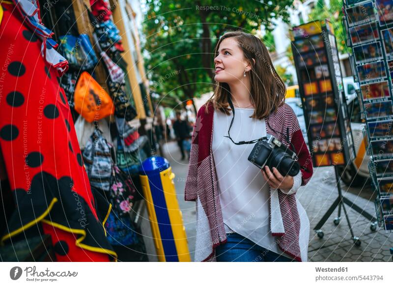 Young woman in Sevilla looking at shops caucasian caucasian ethnicity caucasian appearance european watching shopping camera cameras waist up Waist-Up
