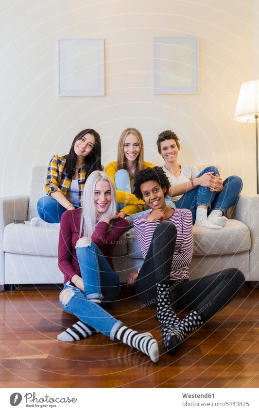 Portrait of group of female friends in living room portrait portraits sitting Seated smiling smile home at home woman females women living rooms livingroom