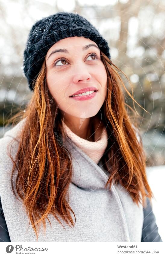 Young woman outdoors in winter looking up females women smiling smile portrait portraits Adults grown-ups grownups adult people persons human being humans