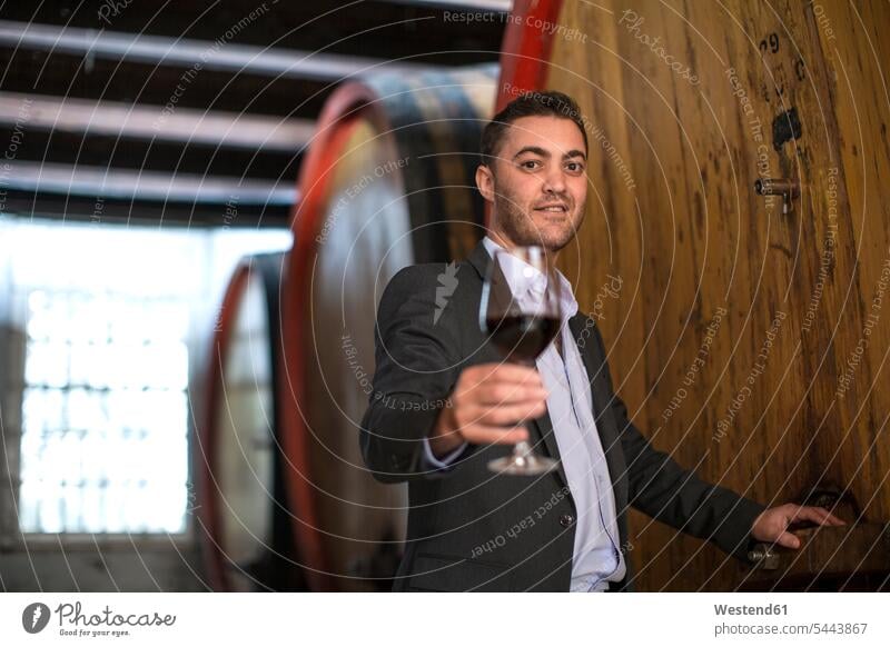 Young man testing red wine at wine estate mid adult men mid adult man mid-adult men mid-adult man wine farm Wine Tasting wine-tasting winetasting Red Wine