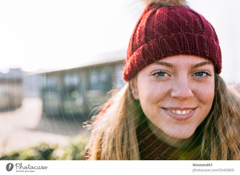 Portrait of smiling teenage girl wearing woolly hat human human being human beings humans person persons Teen Teenage teenagers Teens female female teenager