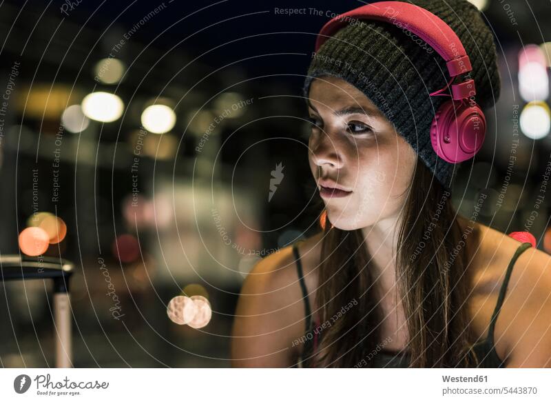 Portrait of young woman with headphones at night females women headset by night nite night photography Adults grown-ups grownups adult people persons