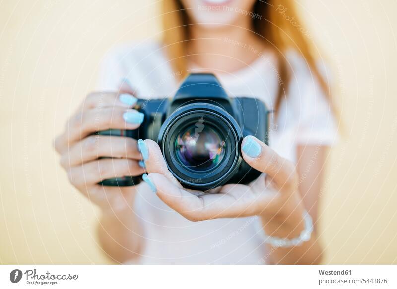 Close-up of woman's hands holding a camara females women camera cameras human hand human hands Adults grown-ups grownups adult people persons human being humans