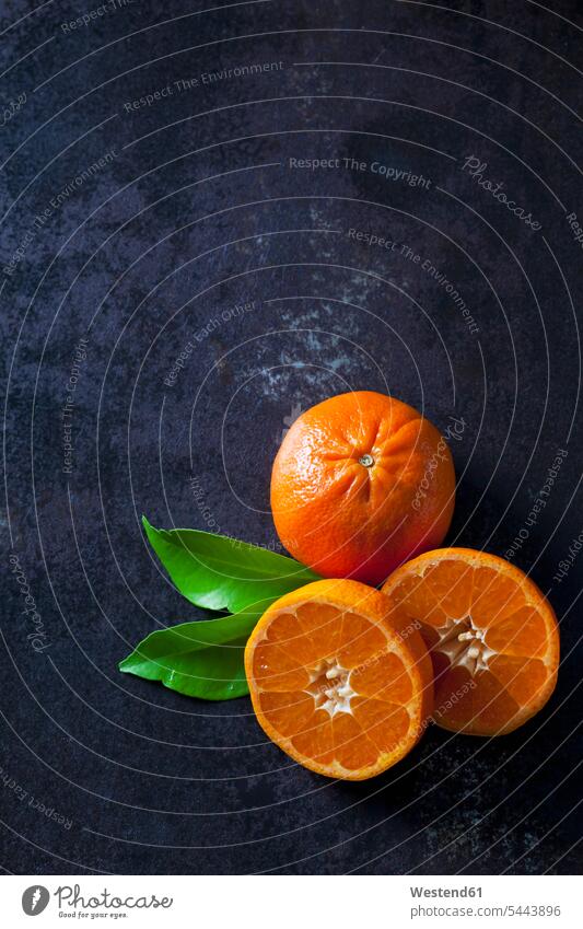 Sliced tangerines on dark backround copy space elevated view High Angle View High Angle Shot healthy eating nutrition half halves halved sliced juicy organic