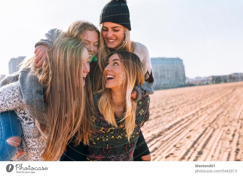 Four friends having fun on the beach mate female friend beaches Emotions Feeling Feelings Sentiment Sentiments laugh Laughter human human being human beings