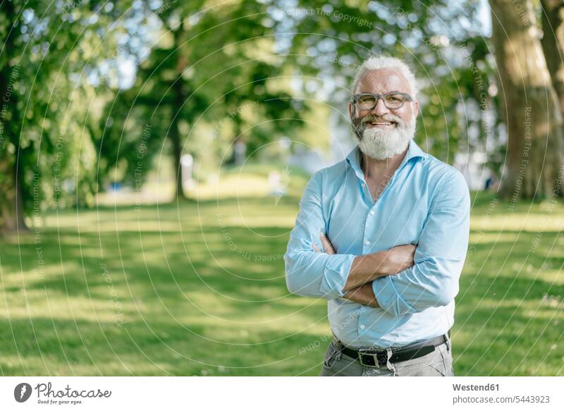 Portrait of smiling mature man with beard and glasses outdoors smile men males portrait portraits standing Adults grown-ups grownups adult people persons