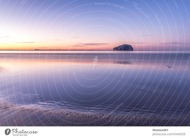 UK, Scotland, North Berwick, Firth of Forth, view of Bass Rock at sunset seafront seashore Oceanside Sea Shore afterglow Afterglow Vista Long Exposure