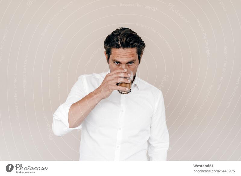 Businessman drinking from glass men males portrait portraits Business man Businessmen Business men Adults grown-ups grownups adult people persons human being