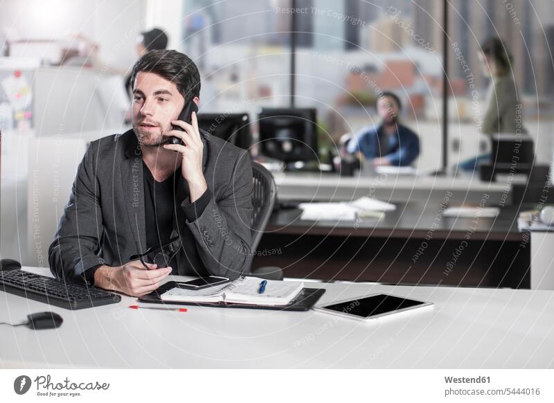 Businessman on the phone in office Business man Businessmen Business men mobile phone mobiles mobile phones Cellphone cell phone cell phones offices office room