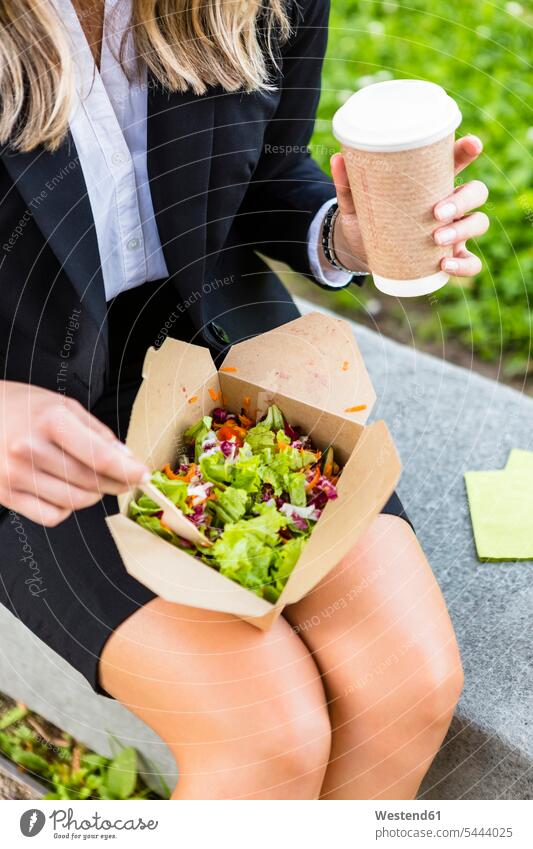 Businesswoman having lunch outdoors, partial view businesswoman businesswomen business woman business women eating Lunch business people businesspeople