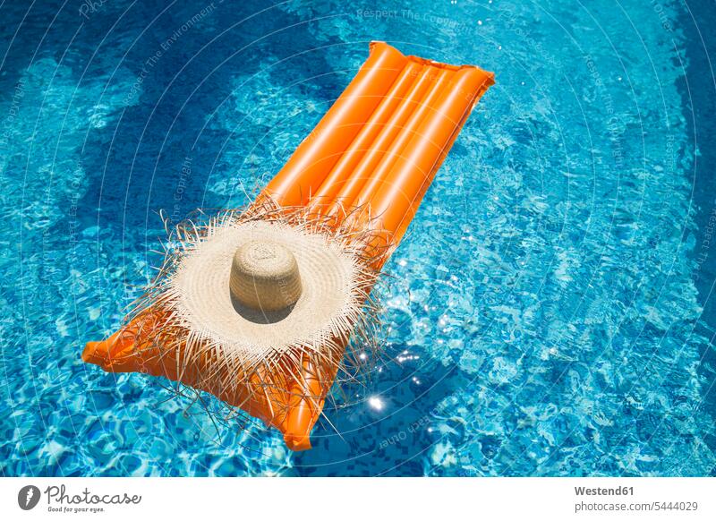 Straw hat on orange airbed in swimming pool pools swimming pools getting away from it all Getting Away From All unwinding relaxing day daylight shot
