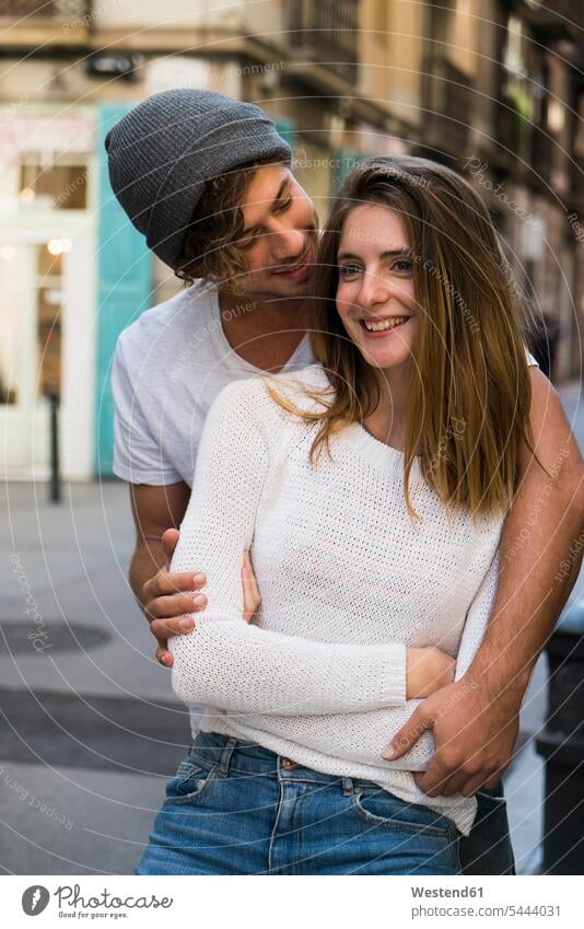 Smiling young couple in the city twosomes partnership couples Love loving embracing embrace Embracement hug hugging smiling smile people persons human being