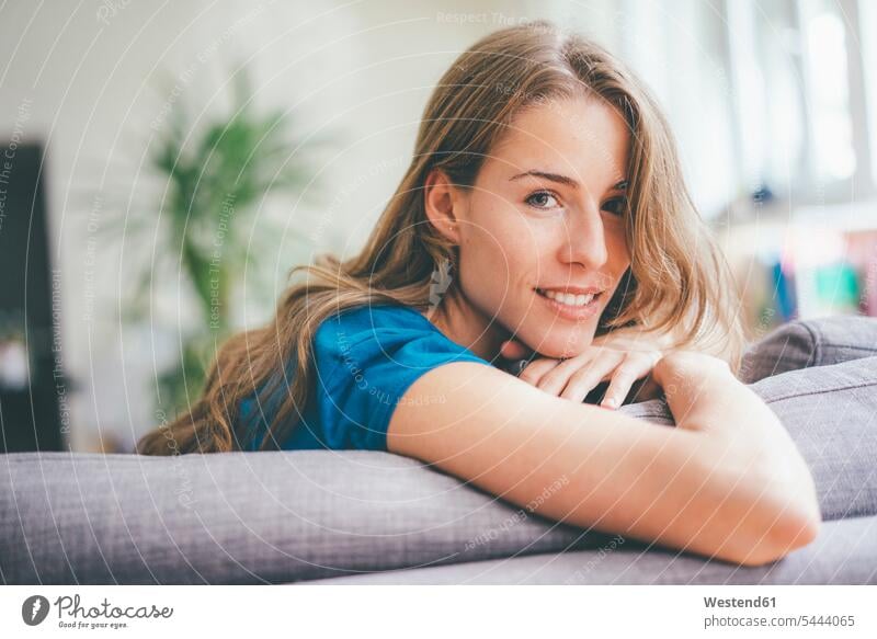 Portrait of young woman relaxing at home females women smiling smile relaxed relaxation portrait portraits Adults grown-ups grownups adult people persons