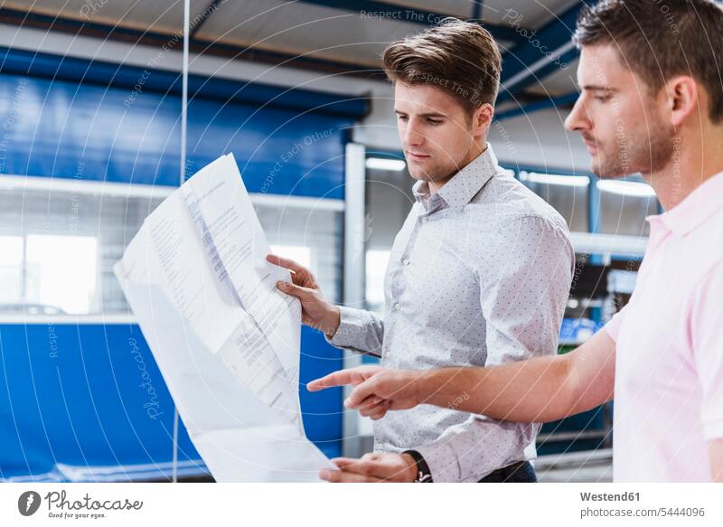 Two businessman standing in shop floor, discussing plans production hall Business Meeting business conference meeting discussion holding Meetings