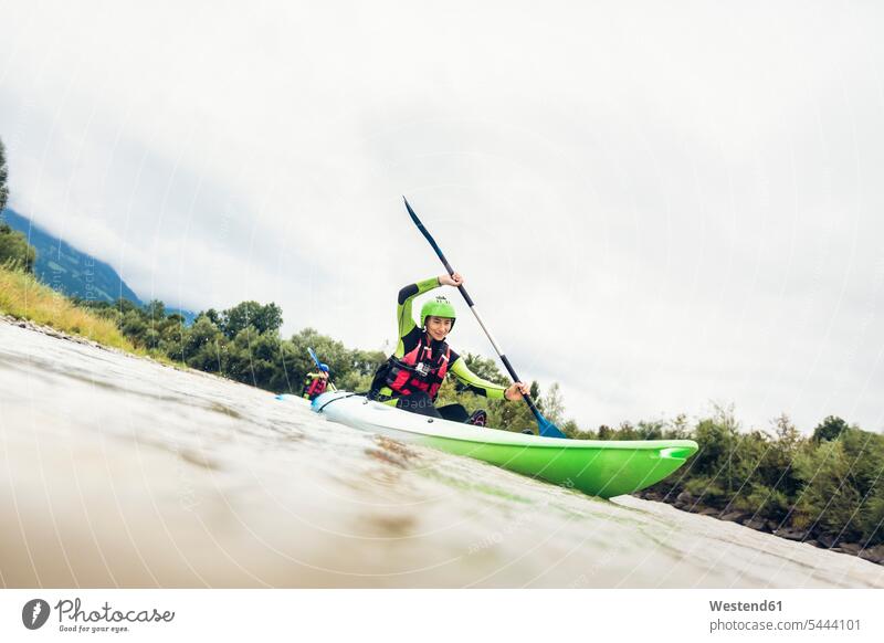 Germany, Bavaria, Allgaeu, couple kayaking on river Iller paddling paddle River Rivers canoe water sports Water Sport aquatics waters body of water canoes boat