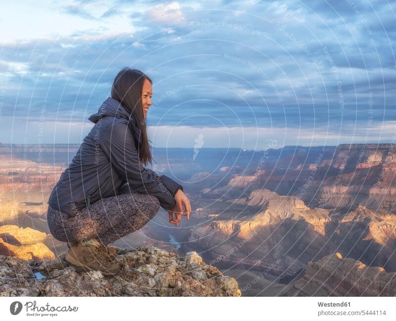 USA, Arizona, Grand Canyon National Park, tourist enjoying the view rock rocks landscape landscapes scenery terrain crouching cowering sky skies Travel high