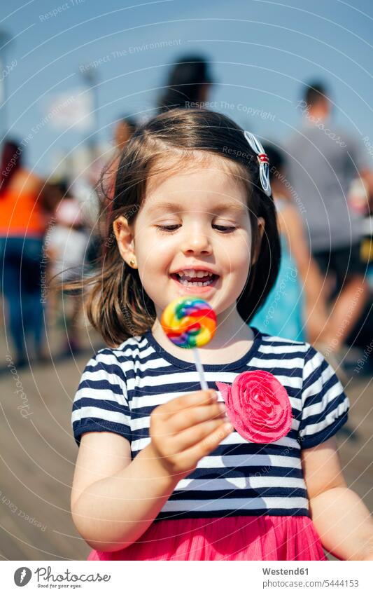 USA, New York, Coney Island, happy little girl with lollipop Lollipop Lollipops Lolly females girls Sweets Candies Sweet Food foods food and drink Nutrition